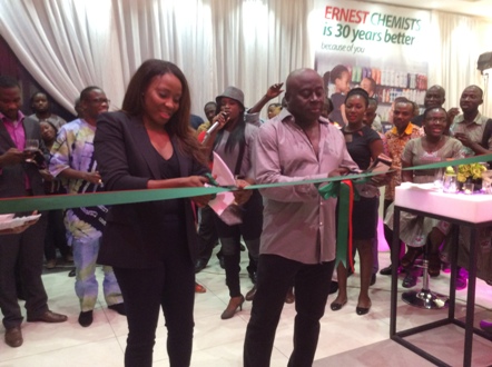 CEO of Ernest Chemist, Ernest Bediako Sampong and Retail Manager, Adjoa Akyema Bediako Sampong cutting the tape