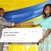 The CEO of UMB, Mr. John Awuah presenting the scholarship to Jessica Ayeley Quaye