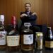 Suntory Holdings Ltd's President and CEO Takeshi Niinami speaks behind the company's alcoholic beverages during an interview with Reuters at the company headquarters in Tokyo, Japan, October 26, 2015.  REUTERS/Toru Hanai