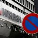The company logo of Mitsubishi Motors is seen behind a traffic sign at its headquarters in Tokyo, Japan, August 2, 2016. REUTERS/Kim Kyung-Hoon