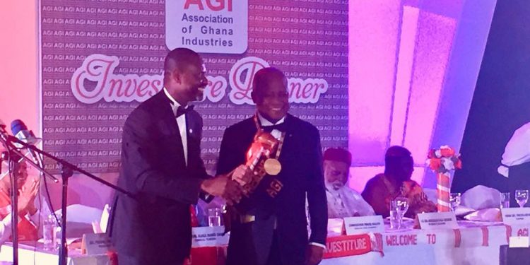 Outgoing AGI president, Mr. James Asare Adjei handing over to the newly sworn-in president of the AGI, Dr. Yaw Adu Gyamfi