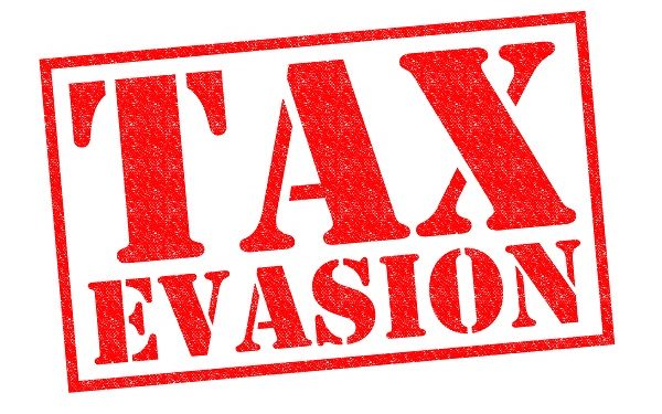 TAX EVASION red Rubber Stamp over a white background.